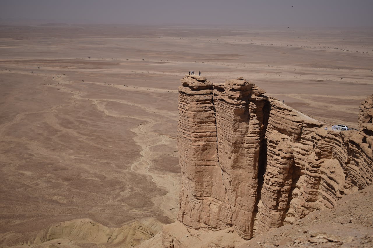 A breathtaking view of the rugged Tuwaiq escarpment rising above the Saudi Arabian desert.